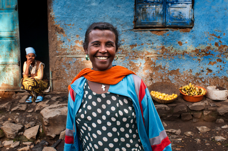 Woman outside of one of the oldest houses in the city of Gondar, Ethiopia (photo)