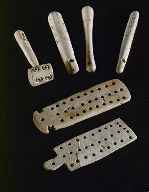 Pendants and two plaques with 30 holes (bone)