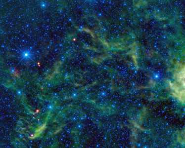 The star cluster NGC 2259 is overshadowed by the surrounding stars and dust which glow brightly in infrared light. WISE.