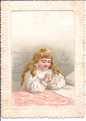 A Victorian hold-to-light Christmas Card of a young girl praying. When the card is held in front of a light source a group of angels appear, circa 1890 (coloured lithograph)