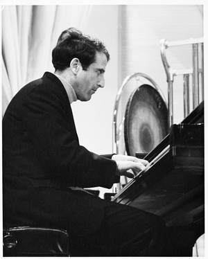 Lukas Foss, composer and conductor, seated at piano at Second Festival of the Arts, March 1968