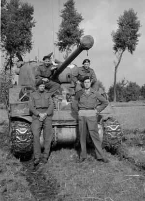 Members of B Squadron, 3rd/4th County of London Yeomanry (Sharpshooters) pose next to Sherman Firefly tank (b/w photo)