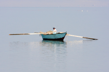 Man in A Fishing Boat on Lake Qarun, El Fayoum, Egypt (photo)