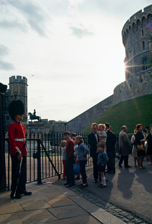 Tourists walk in a castle's courtyard under a guard's watchful eye. Windsor Castle, B…, 1960s (photo)