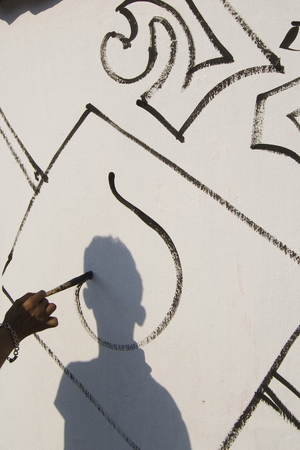 A Bangladeshi fine arts student paints on the ground in front of the Shahid Minar, (Language Movement Mausoleum) in Dhaka, 20 February 2007, as part of preparations for the forthcoming Lanuage Martyrs Day and International Mother language Day. Language Martyrs Day is marked in Bangladesh to commemorate those who died during protests on 21 February 1952 against the then Pakistani states governments decission to name Urdu as the national language, despite East Pakistan's (Now Bangladesh) Bengali speaking majority. The International Mother Language Day is observed yearly in UNESCO member states and at its headquarters to promote linguistic and cultural diversity.  (photo)