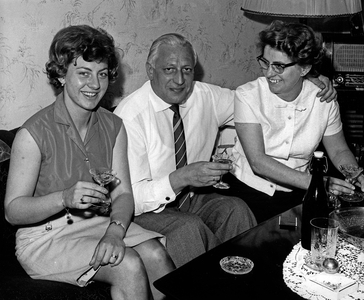 A man and two women having a liqour in the afternoon, Germany 1960s