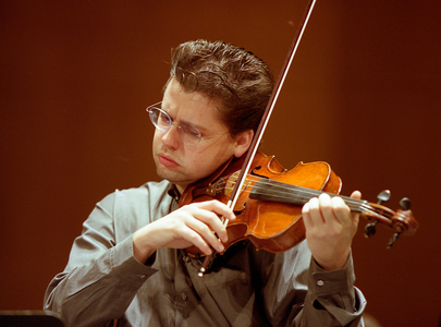 Julian Rachlin playing the violin with the National Orchestra of France, March 2006.  Lithuanian born Austrian violinist. b. 1974.