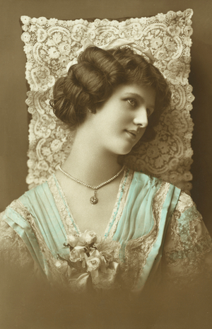 Portrait of a young woman and lace (coloured photo)