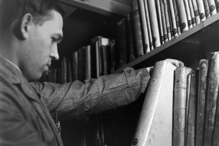Staff members in their daily business with collections and items for international library lending service at Deutsche Staatsbibliothe library at Berlin Unter den Linden, Germany 1930s (b/w photo)