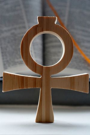 Bible and the Ankh, symbol from ancient Egypt, known as the key of life or the cross of life, The ankh as a form of the Christian cross, symbolizing eternal life through Christ (photo)