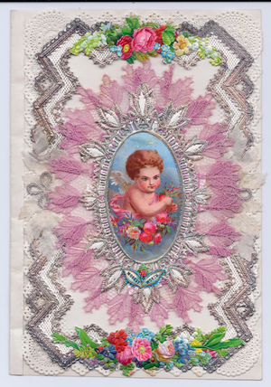 A Victorian decoupage embossed paper lace greeting card  with cupid surrounded by fabric flowers, c.1880 (colour litho)