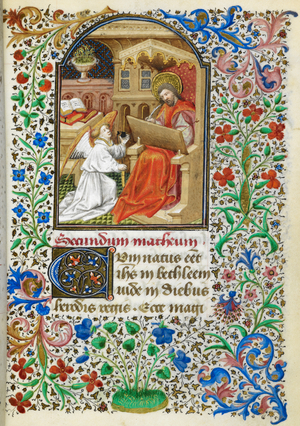 Miniature of Matthew writing at a desk, while his symbol, the angel, holds his ink pot for him, with a full foliate border, at the beginning of his Gospel