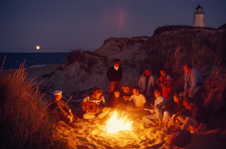 Friends gather around a summer campfire at Great Point Lighthouse. Nantucket Isl,,..., 1970s (photo)