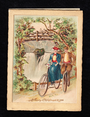 A Victorian three dimensional Christmas card of a man and a woman bicyling next to a waterfall, c.1880 (colour litho)