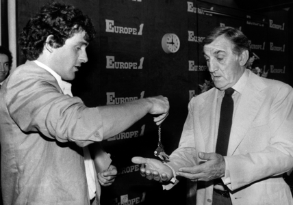 Footballer Michel Platini Offering A Minibus To Lino Ventura For his Medical Association Perce-Neige June 16, 1983 (b/w photo)