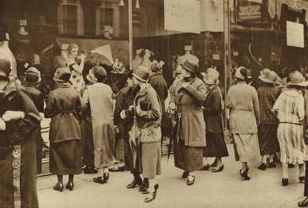 The silent appeal of the all-powerful shop window on the daily crowd of potential customers (b/w photo)