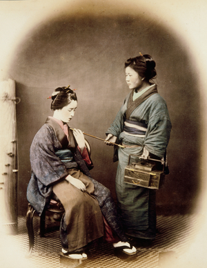 Woman Being handed Pipe by Attendant, 1867 (photo)