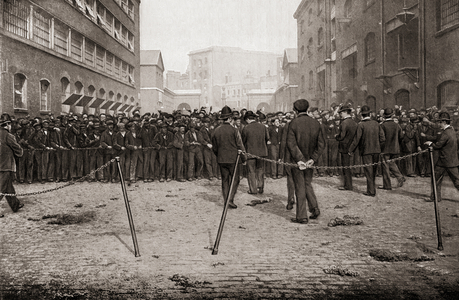 Unemployed men waiting for work on the docks, London, England in the late 19th century.  From Living London, published c.1901