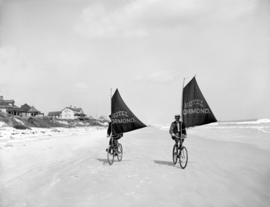 Cyclists riding Sailing Bicycles from The Ormond Hotel on the Beach,  1903 (B/W Photo)