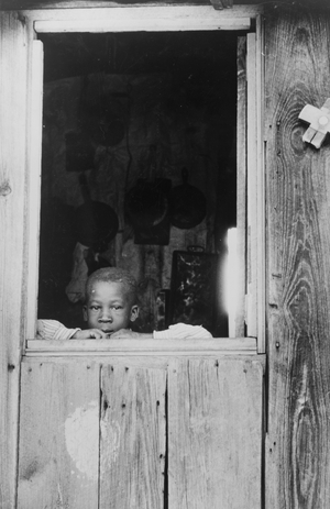 Son of a tobacco tenant farmer in the doorway of their home near Farmingham, North Carolina, 1940 (b/w photo)