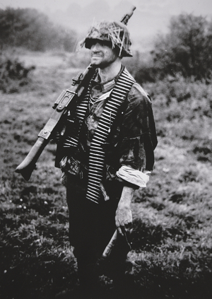 WW2 German infantry soldier armed with MG 34 machine gun and stick grenade, 1939-45 (b/w photo)