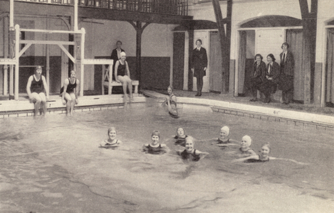 Swimming in the pool at a girls' school (b/w photo)