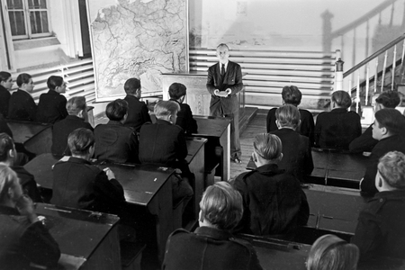 The clergyman is teaching some inmate in a class, correctional faciltity Herford Germany 1950