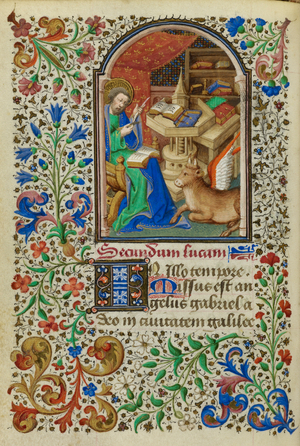 Miniature of Luke seated at a table mending his quill pen with a knife, with his symbol, the winged ox, by his side, and a full foliate border, at the beginning of his Gospel