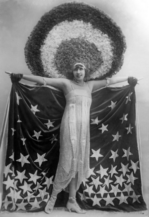 Mistinguett wearing giant headgear in her show in Paris, 1917