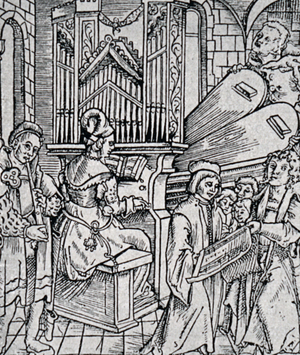 A large organ being played by an organist