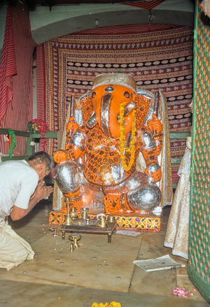 Worship at garlanded Ganesh shrine, Jaipur, Rajasthan, India, 1977 (photo)