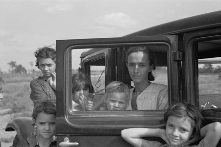 The family of a migratory fruit worker from Tennessee now camped in a field near the packinghouse at Winter Haven, Florida, 1937 (b/w photo)