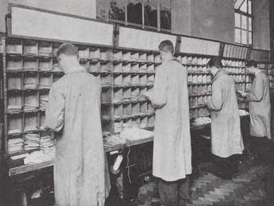 Sorting letters at a post office (b/w photo)