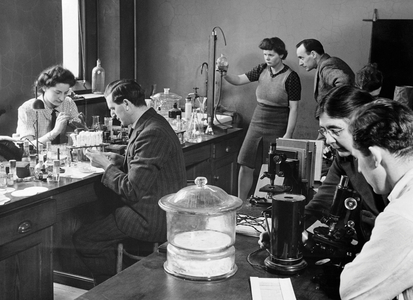 College students with their professors in a botanical laboratory, King's College, Durham University, England