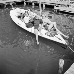 Three young women on a sailing boat on a lake in the Wachau area in Austria, Germany 1930s (b/w photo)