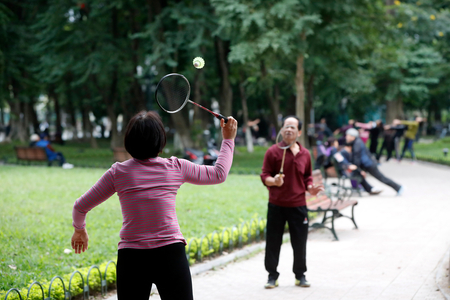 Badminton players along the banks of Hoan Kiem lake, Hanoi, Vietnam (photo)