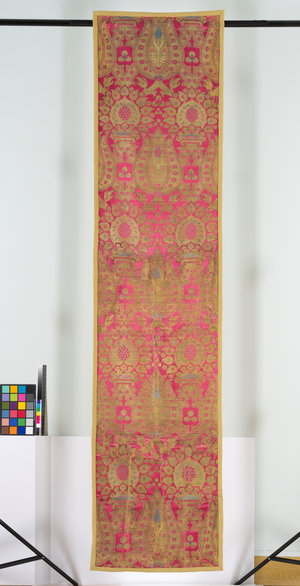 Lampas textile panel, 1550-99 (lampas, red warp-faced satin ground with pattern formed by silk wefts of light blue and yellow with fragments of the black originally used for outlining the large areas of gilt metal thread, now largely worn down to its silk core)