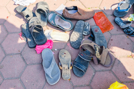 Thaipusam Festival: Discarded shoes at the base of the steps to the Batu Caves, Kuala Lumpur, Malaysia
