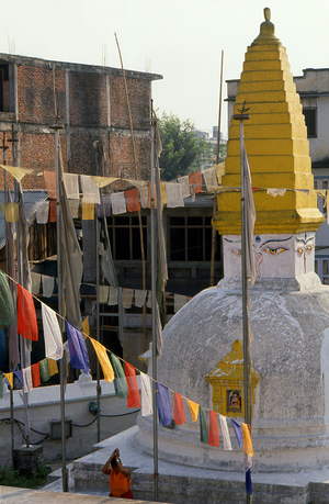 Nepal: A monk prays next to a small stupa, Swayambhunath (Monkey Temple), Kathmandu Valley
