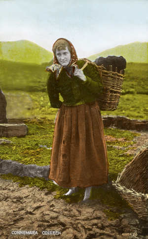 Connemara colleen / Irish woman with a basket of turf, 1900s (postcard)
