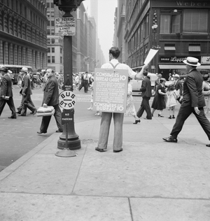 Street hawker selling Consumer's Bureau Guide in New York City, 1939 (b/w photo)