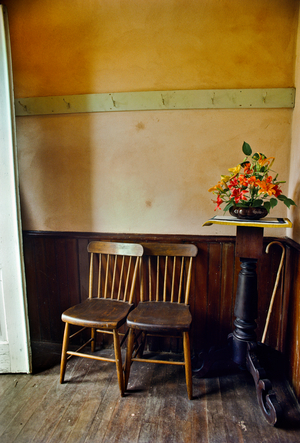 Old chairs nuzzle in the prim foyer of Minnesota City Baptist Church., 1976 (photo)