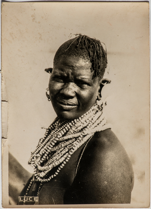 Portrait of a woman from the tribe of Turkana. The woman has a hairstyle of pigtails and wears a characteristic beaded collar, 1930 (photo)