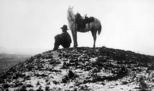 Lone cowboy with his horse, c.1910 (b/w photo)