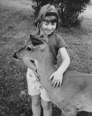 Girl stroking fawn