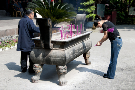 China: Placing incense  in the Qingyang Gong (Green Goat Temple), Chengdu, Sichuan Province
