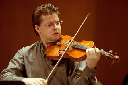 Julian Rachlin playing the violin with the National Orchestra of France, March 2006.  Lithuanian born Austrian violinist. b. 1974.