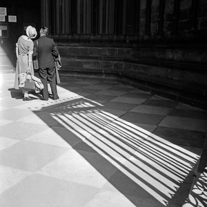 A couple standing at the minster of Freiburg on a sunny day, Germany 1930s (b/w photo)