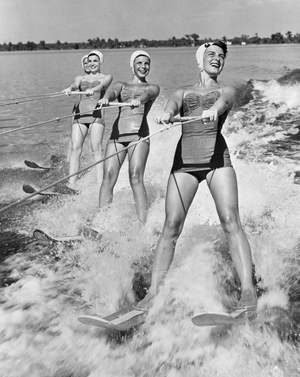 Four young women waterskiing in the sea