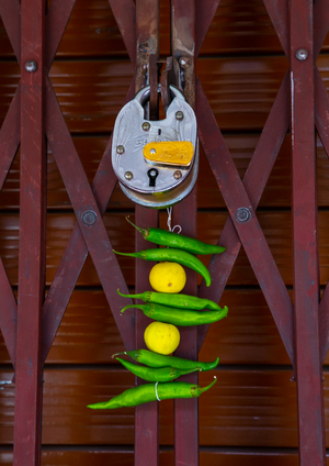 Lemon and green chilli tied on a thread hung outside a door to keep away Alakshmi, Rajasthan, Jaipur, India, 2019 (photo)